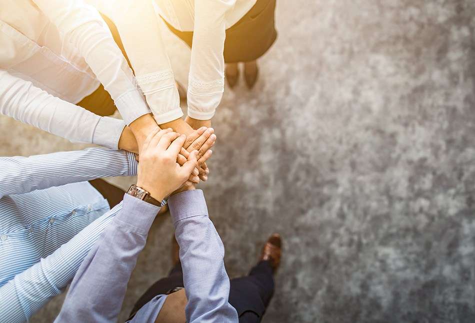 stack of hands unity and teamwork 950x645 1